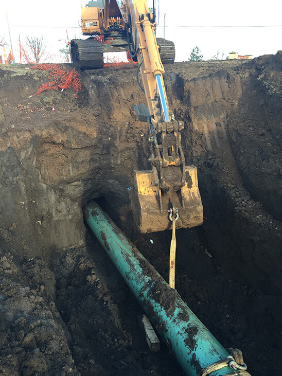 Back Hoe Digging Pipeline